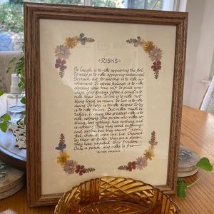 Beautiful pressed flowers with quote in frame